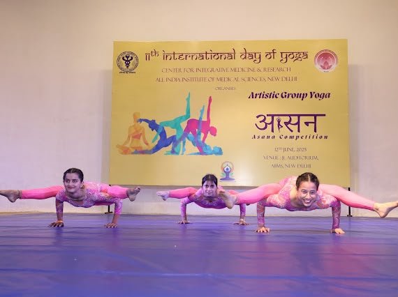Students competing in an artistic group yoga asana competition