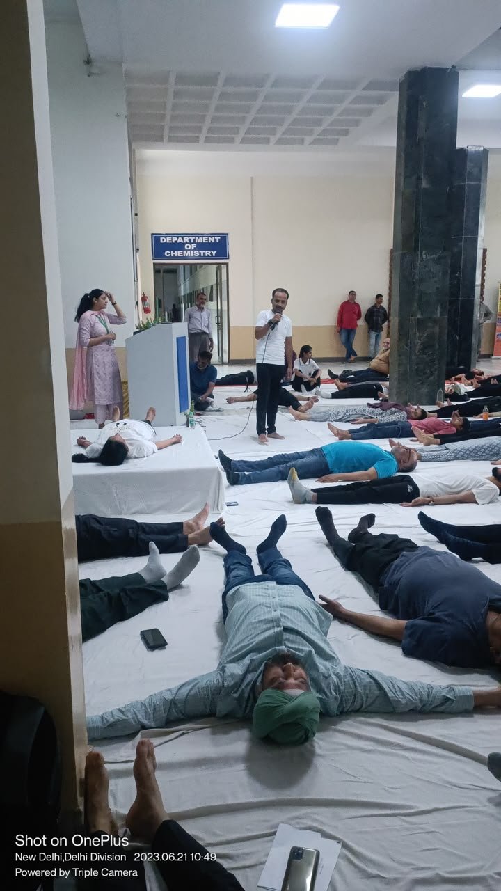 Office team relaxing in savasana during a workplace yoga session