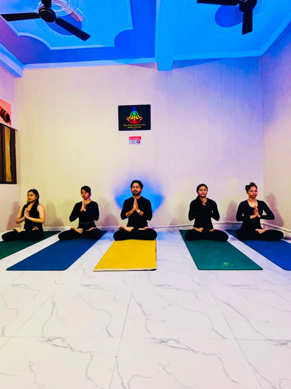 Yoga class seated in meditation during a guided breathwork session